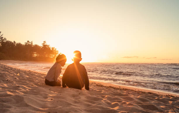 istock Boy watching beautiful sunset in the beach park. 1619237605