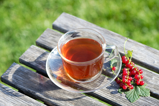 Woman sitting on the terrace and  pouring  masala chai to the cup