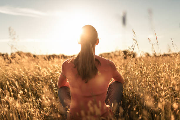 Woman sitting in the field.