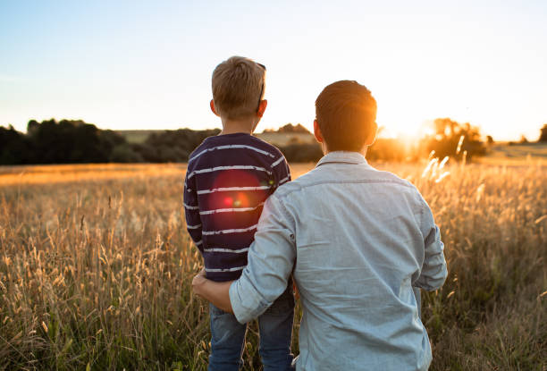 istock Father and son enjoying beautiful sunset. 1619246651