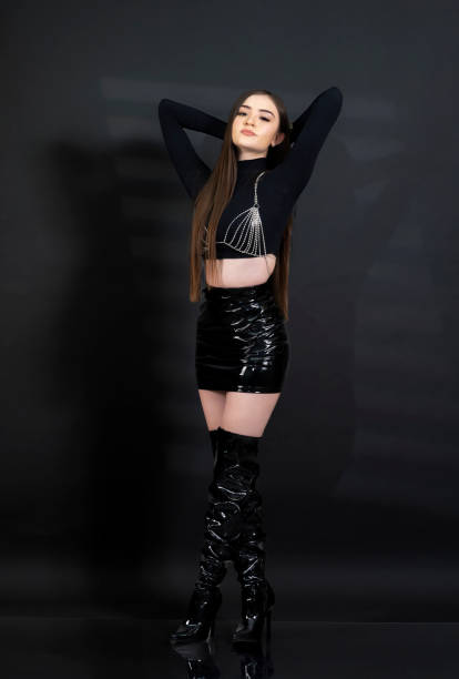 istock Young woman in modern clothes in photo studio 1619248220