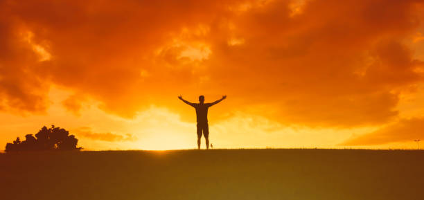 istock Man with open arms enjoying peace in nature. 1619250449