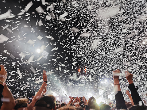 White confetti at a concert, in the evening. real photo.