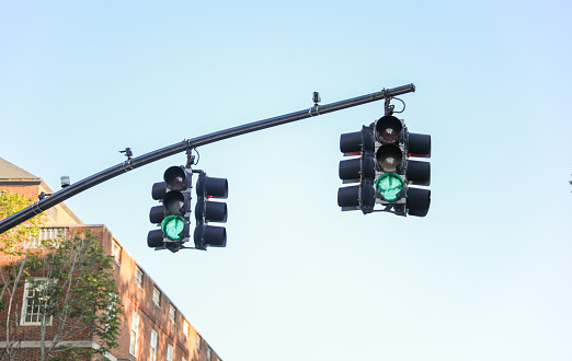 Illuminating pathways and guiding traffic, street lights and traffic lights symbolize safety, order, and urban connectivity