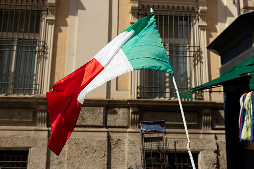 Italian Flag over window's house in the Italian street.