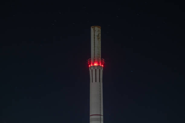 Long exposure of an illuminated industrial chimney
