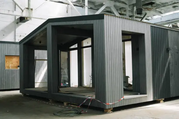 A new wooden modular prefabricated house inside in manufacturing facility.
