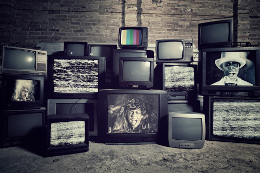 Stack televisions in a Warehouse  with people screaming . All images are my Copyright .