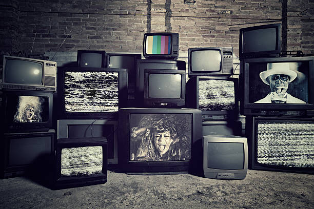 Mad about televisions Stack televisions in a Warehouse with people screaming . All images are my Copyright . old television stock pictures, royalty-free photos & images