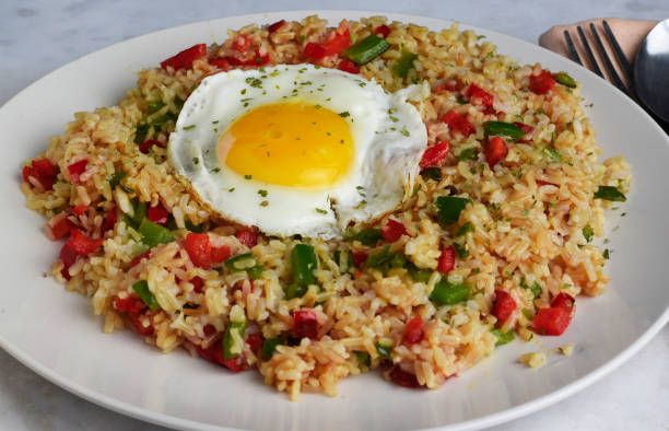 istock brown rice with sauteed peppers and top with fried egg 1619361599