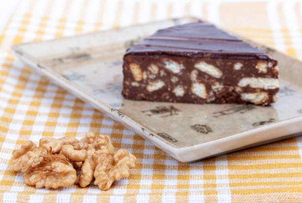 istock Chocolate and walnut cake on a brown plate on a fabric background 1619362132