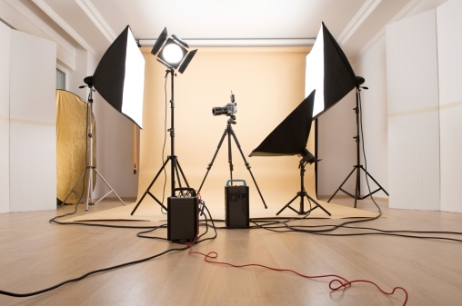 Professional photo studio with flash lights, stands, camera and background equipments