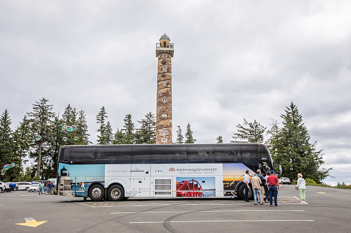 Astoria, United States - August 8, 2023. People board a tour bus at the Astoria Column, Oregon.
