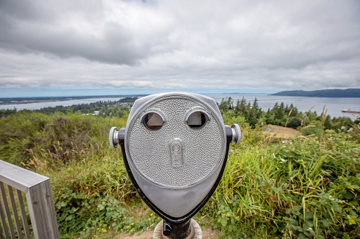 Coin operated binoculars or telescope popular in United States on tourist places. Touristic binocular telescope look at the city with view mountains. Close up Coin operated in panorama observation