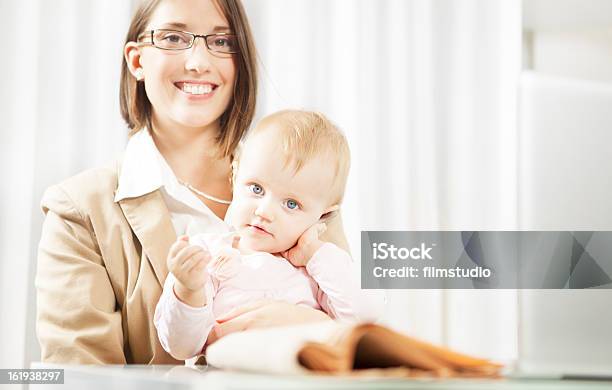 Mother Working With Her Baby During The Work At Home Stock Photo - Download Image Now