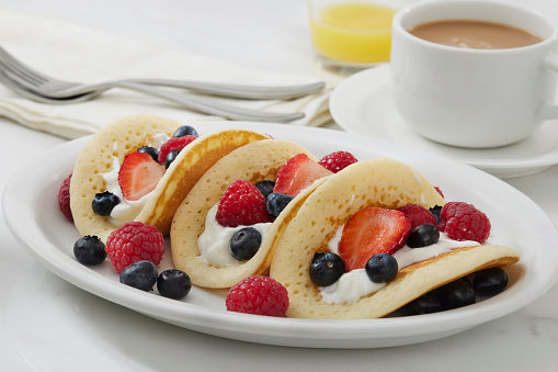 The Viral Pancake Breakfast Taco with Yogurt, Strawberry's, Raspberry's and Blueberries