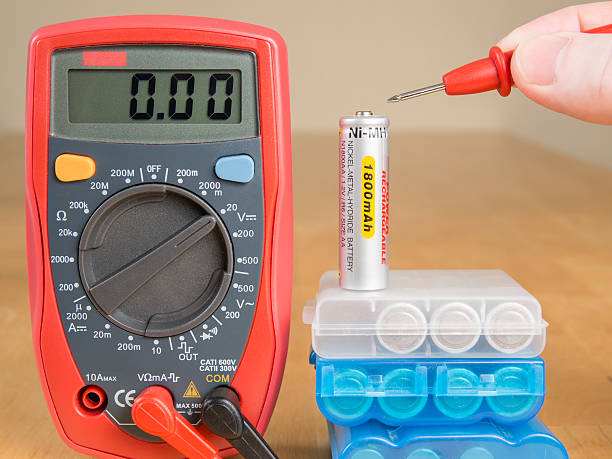 Measuring battery voltage with multimeter stock photo