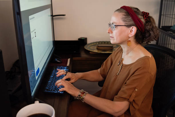 istock Woman living with a visual disability working at home. 1619423602
