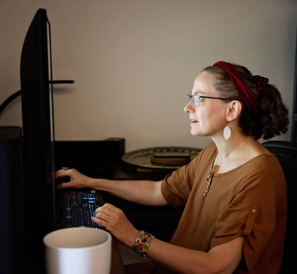 istock Woman living with a visual disability working at home. 1619423610