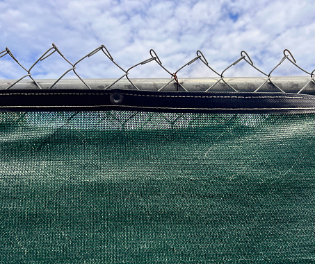 Chain link fence with green mesh