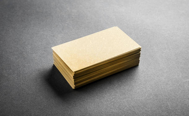 istock Blank golden business card on grey background 1619505625