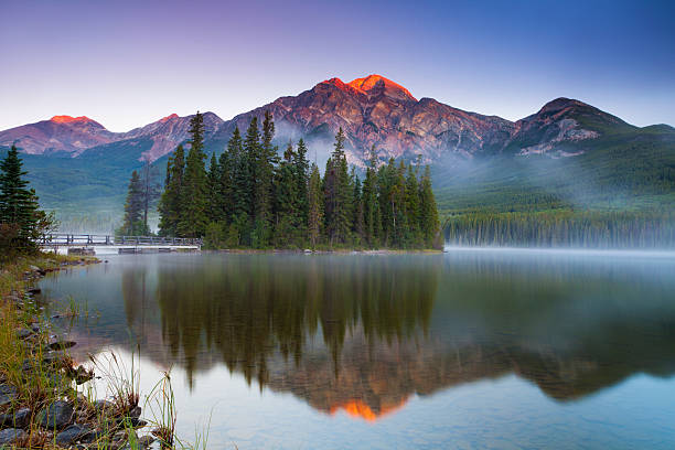 First Light at Pyramid Lake Sunrise at Pyramid Lake in Jasper National Park, Alberta, Canada. jasper national park stock pictures, royalty-free photos & images