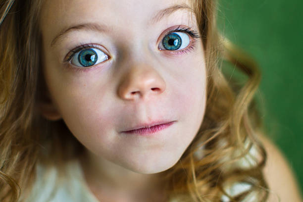 Portrait of a beautiful young girl with huge blue eyes stock photo