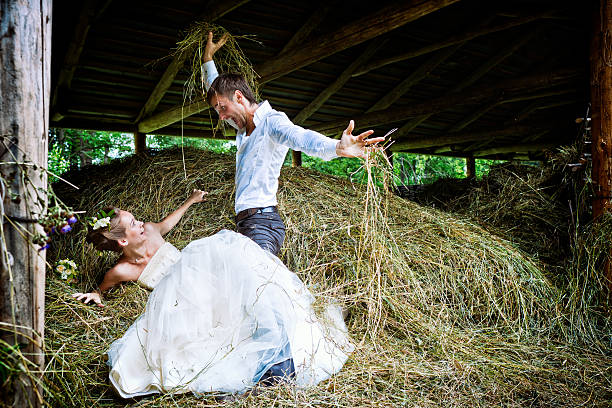 Happy couple have fun in the hayloft stock photo