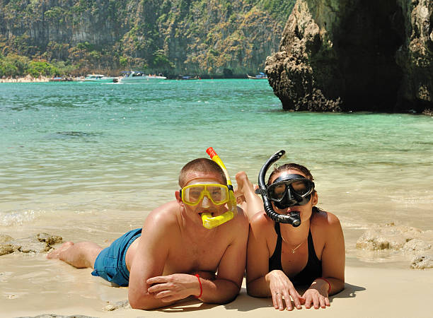 istock Happy couple on the beach dressed in snorkelling. 161956704