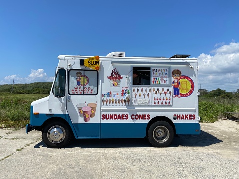 New York, NY USA - August 13, 2023 : Side view of a NYC Soft Ice Cream truck parked on the boardwalk in Jacob Riis Park on a hot summer day in the Rockaways, Queens, New York City