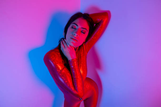istock Female dancer in red catsuit 1619600163