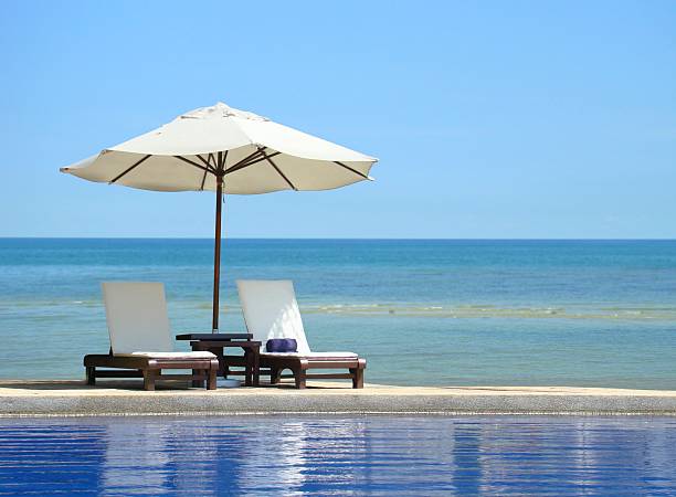 istock Two chairs and white umbrella on the beach 161961719