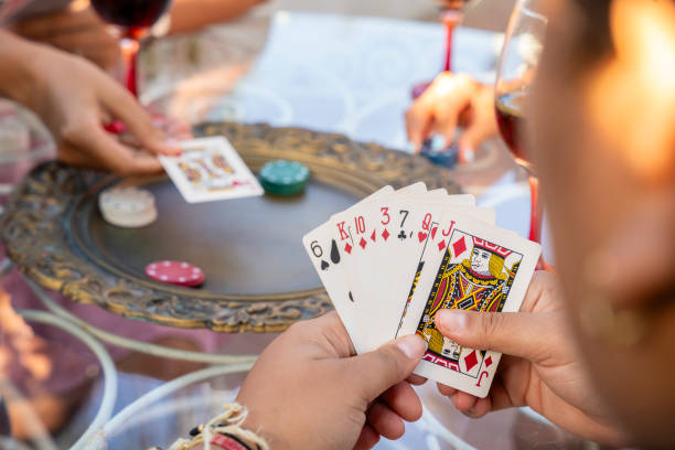 istock Best friends playing cards and having fun together 1619645965