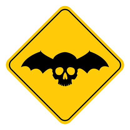 Vector illustration of a black and gold colored winged skull road sign.