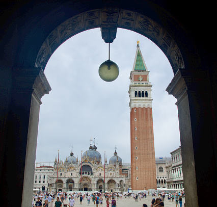 A wide shot of Venice's Campanile and Doge's Palace framed through an archway