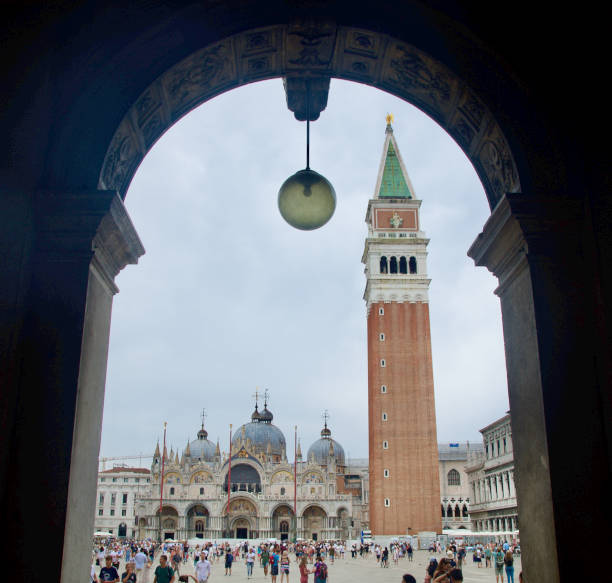 Venice's St. Mark's Square - the Campanile and Doge's Palace framed through an archway stock photo