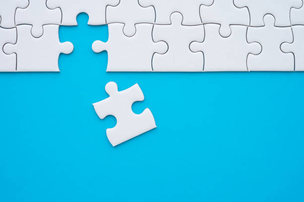 istock The last piece of jigsaw puzzle to complete task on blue background. 1619680275