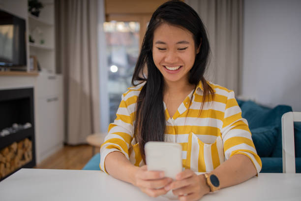 istock Happy young woman using phone 1619710047