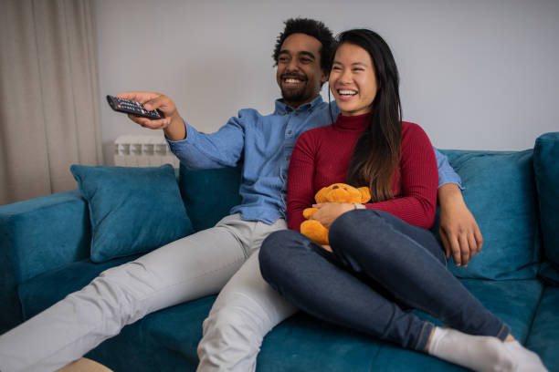 istock Young couple watching TV 1619710599