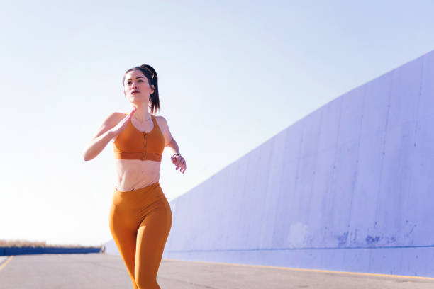 istock caucasian sporty woman running in a athletic track 1619716632