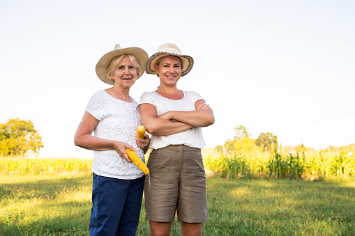 Mother and daughter farmers  standing proud on their property