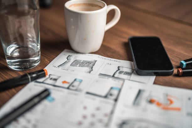 istock Storyboard Editors Table; Coffee, Colored Pencils And A Smartphone 1619735172