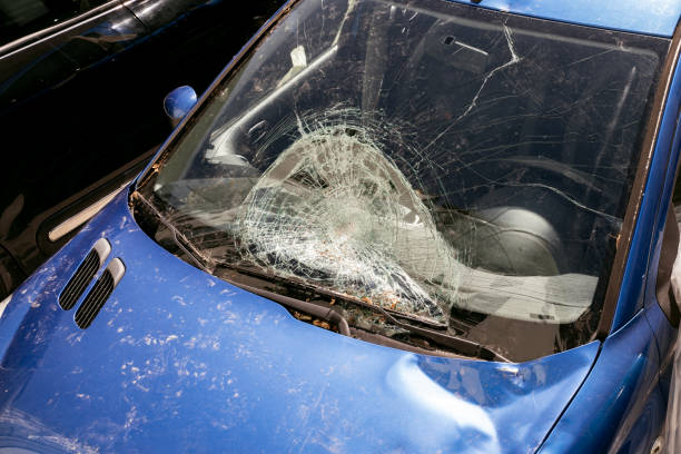 istock Closeup shot of broken windshield on the blue car 1619736828