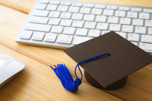 Graduation cap, keyboard with mouse computer table backgrounds. E-learning, online education concept.