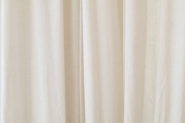 Cream beige curtain fabric texture and background. Smooth elegant cream Satin. Background for grand opening ceremony.