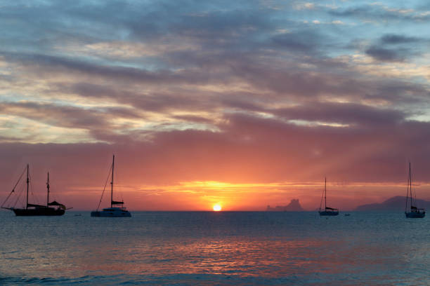 maravilhoso pôr do sol perto da praia ses illetes em formentera, ilhas baleares, espanha. - illetes - fotografias e filmes do acervo