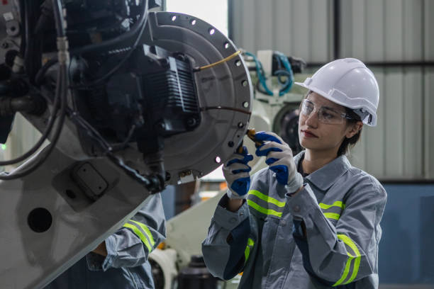 istock Engineers woman maintenance robotic arm. Female technician industrial checking robot machine. Futuristic industry production manufacturing. 1619818362
