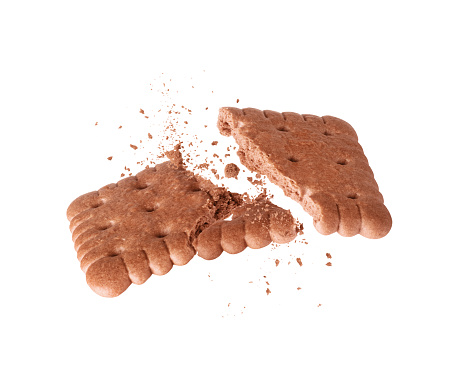 Delicious crispy cookie with cocoa flavor crushed into two halves in the air close-up