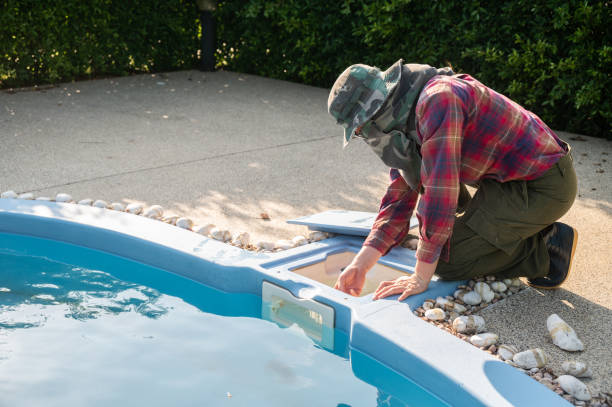 istock Technician trying to check pool skimmer. Its purpose is to clean the surface by sucking water into a conduit system. 1619841863
