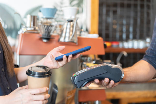 istock Woman use smartphone to scan QR code to pay in cafe restaurant with a digital payment without cash. Choose menu and order accumulate discount. E wallet, technology, pay online, credit card, bank app. 1619848113